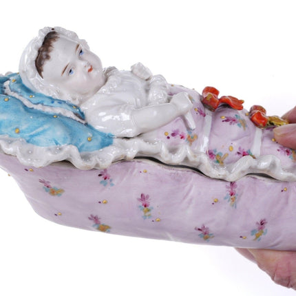 c1870 European porcelain Covered dish with baby in crib