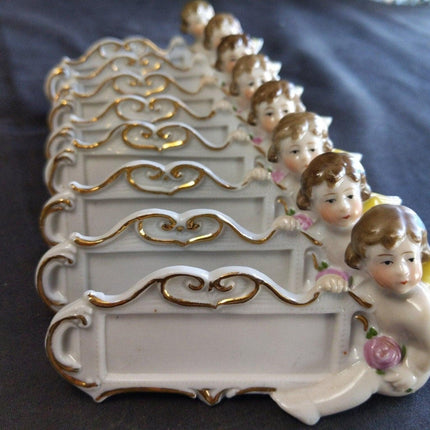 8 c.1920 German Porcelain Dinner Table Place Holders Cherubs