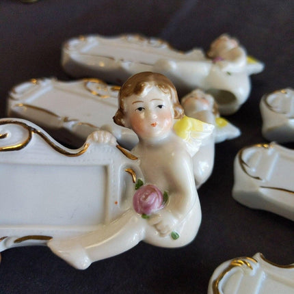 8 c.1920 German Porcelain Dinner Table Place Holders Cherubs