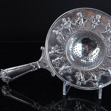 800 Silver Tea Strainer Allegorical Cherubs dancing and playing instruments