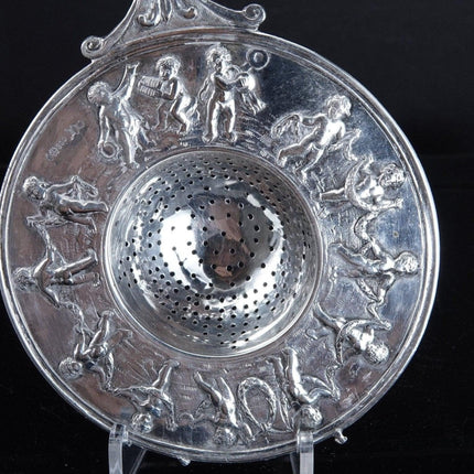 800 Silver Tea Strainer Allegorical Cherubs dancing and playing instruments