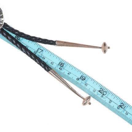 Vintage Navajo sterling silver bolo tie with stamped concho style slide