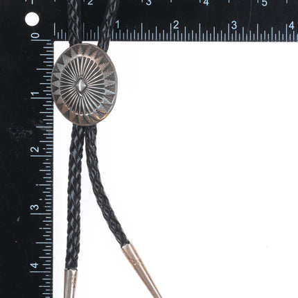 Vintage Navajo sterling silver bolo tie with stamped concho style slide